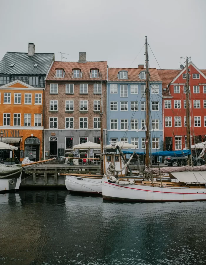Scenic view of colorful buildings and boats along Nyhavn Canal in Copenhagen, Denmark.